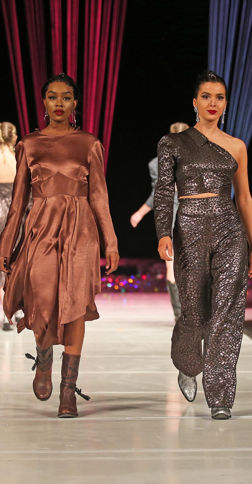 Two models walk the runway during The Fashion Show event