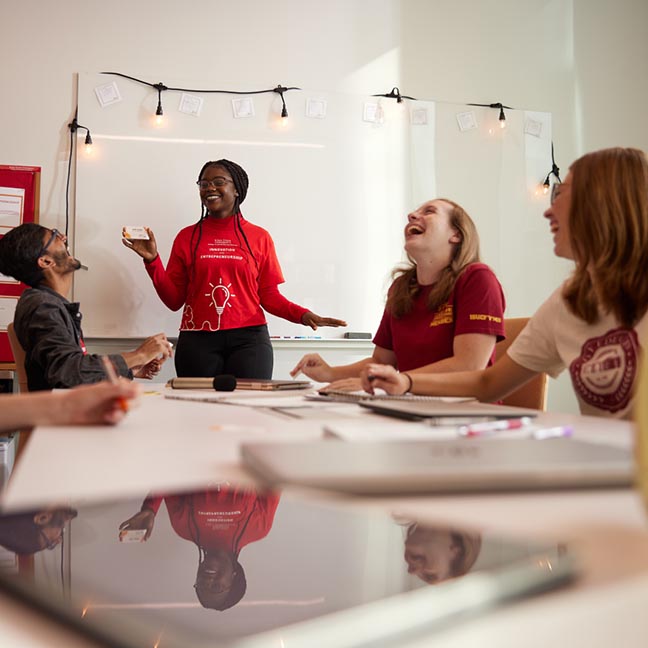 Students laugh during a small group game activity