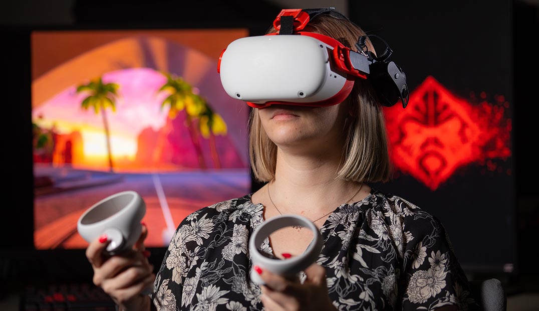 A student uses virtual reality goggles while interacting with a simulation