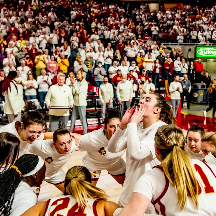 The women's basketball team huddles before a game