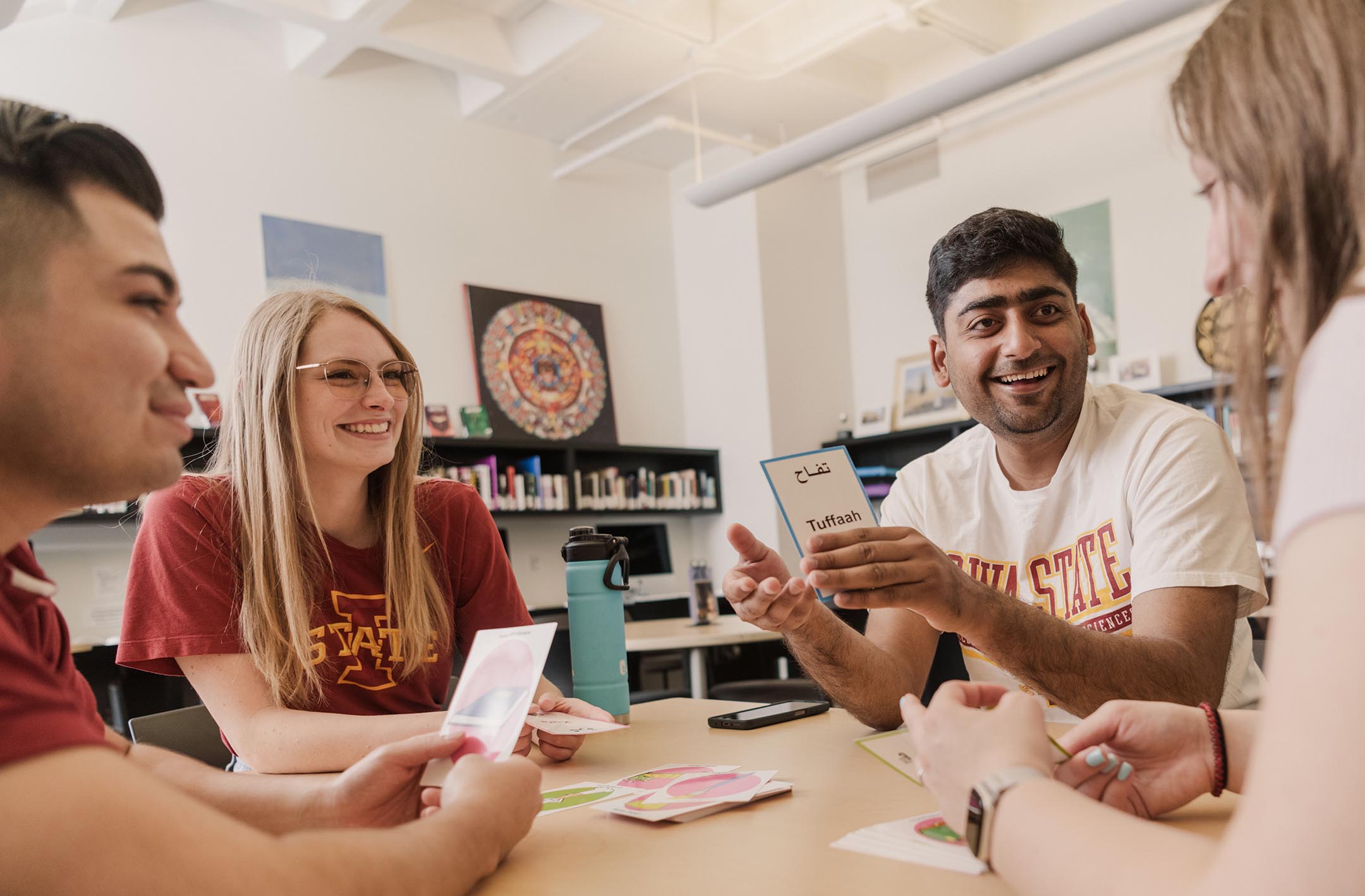 A group of four students study together at a table.