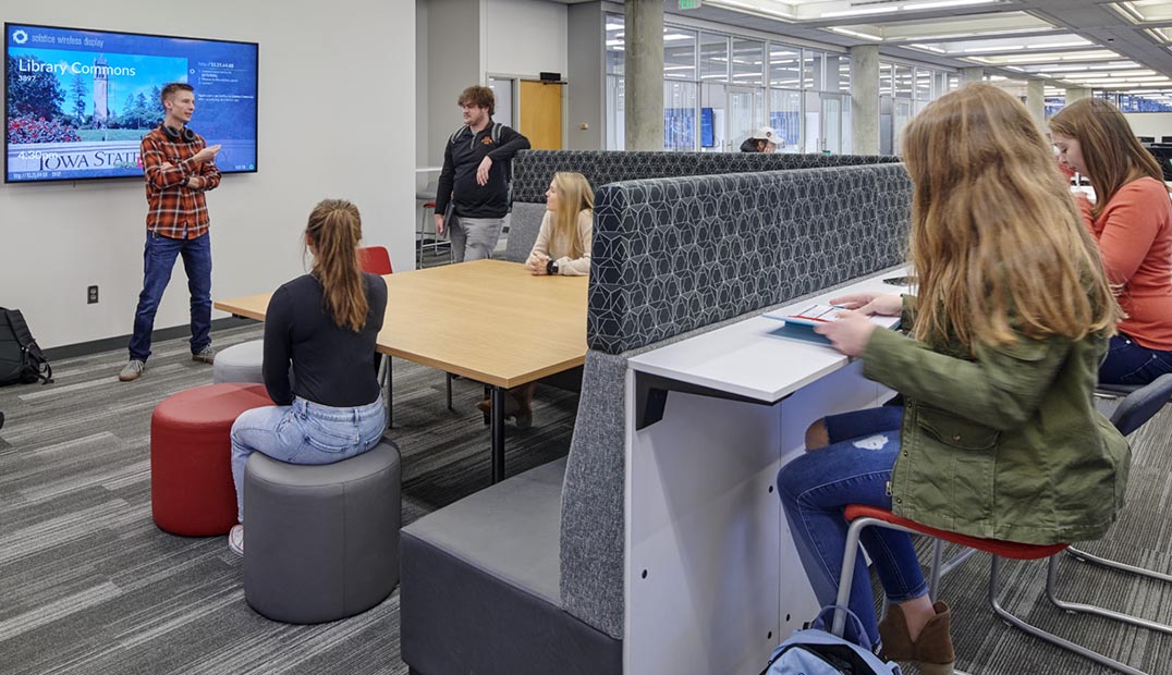 Students work in an interactive area of the library.