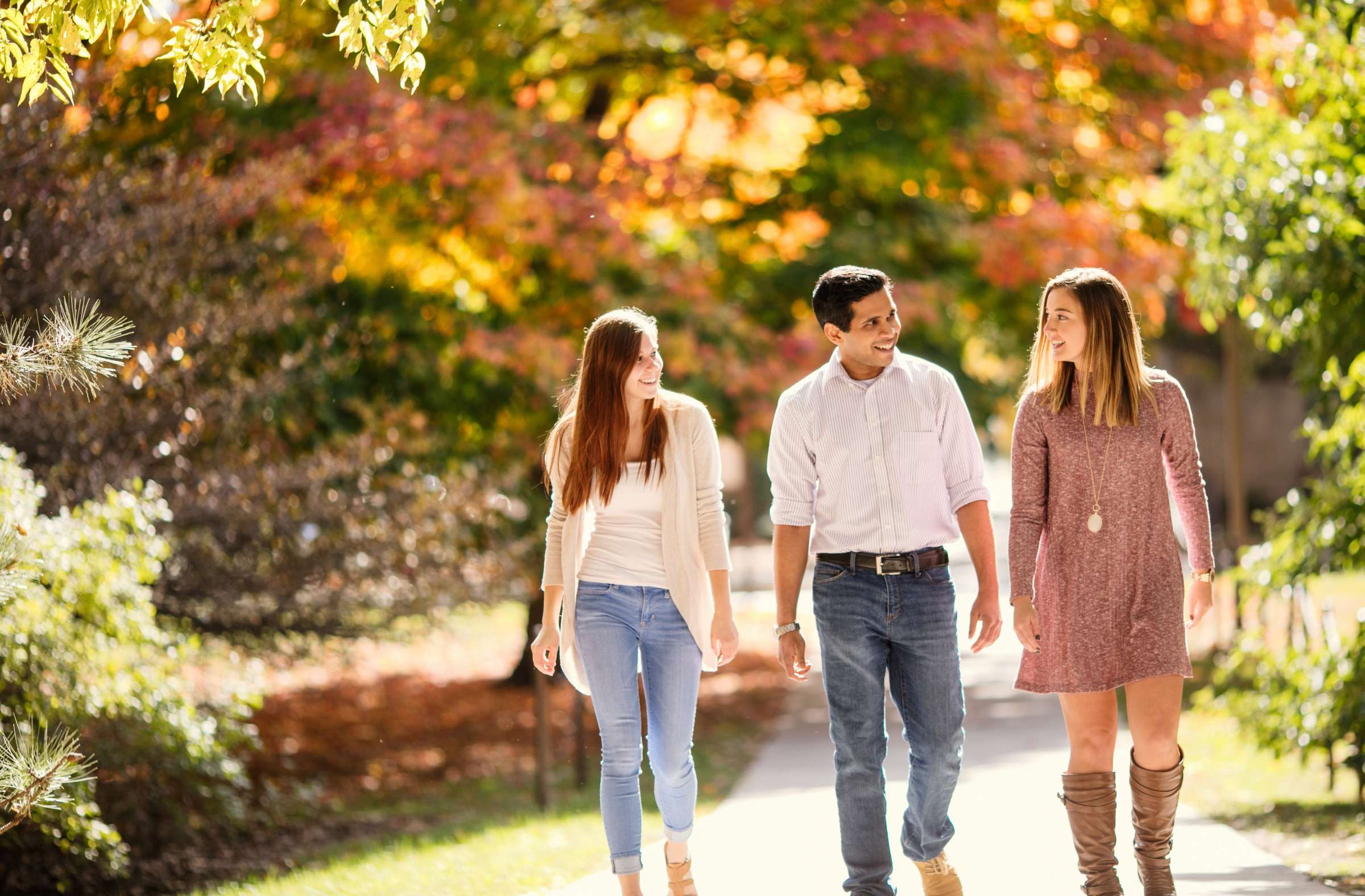 Three students walking on campus