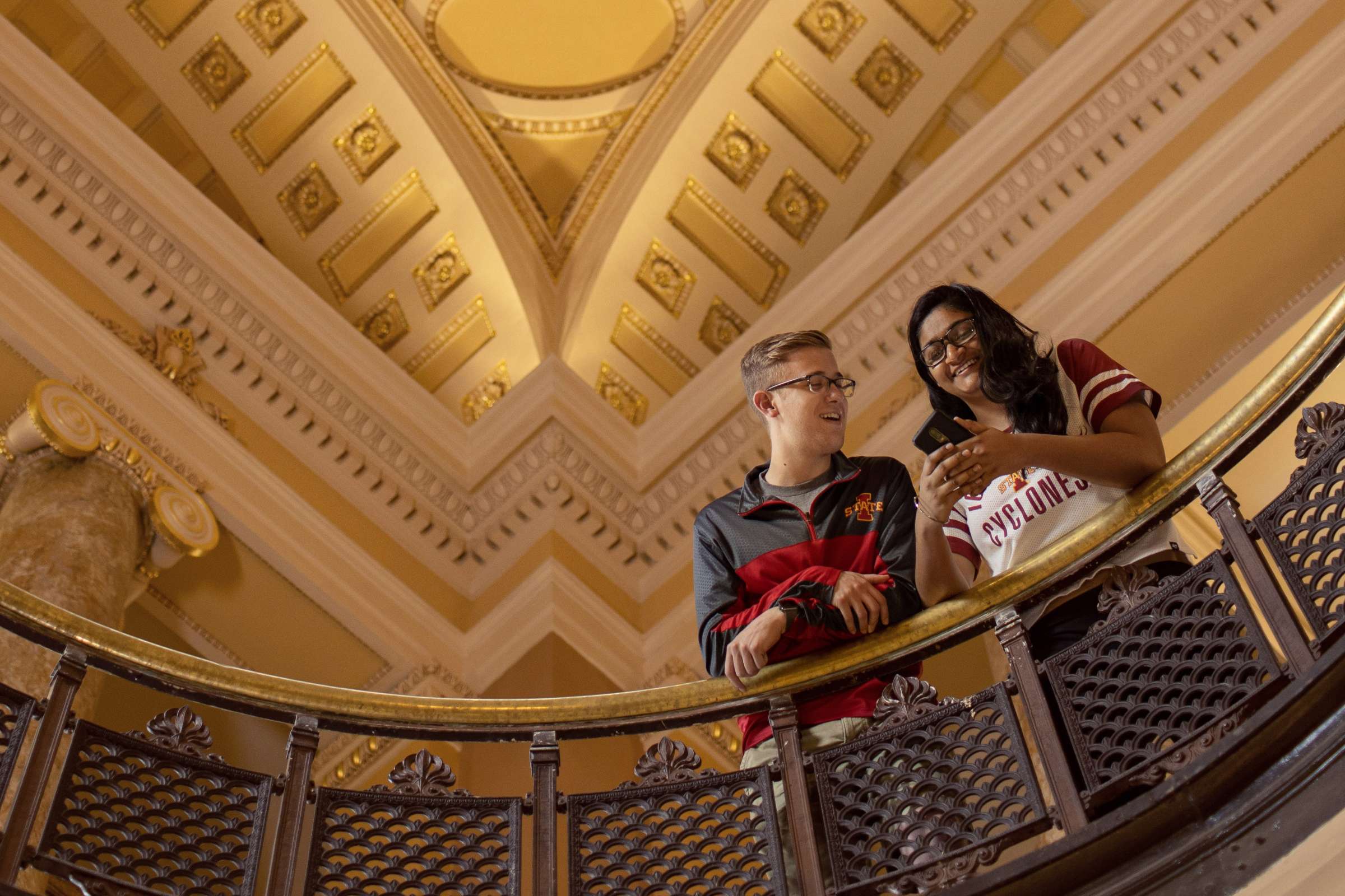 Two students looking at phone in Beardshear Hall 