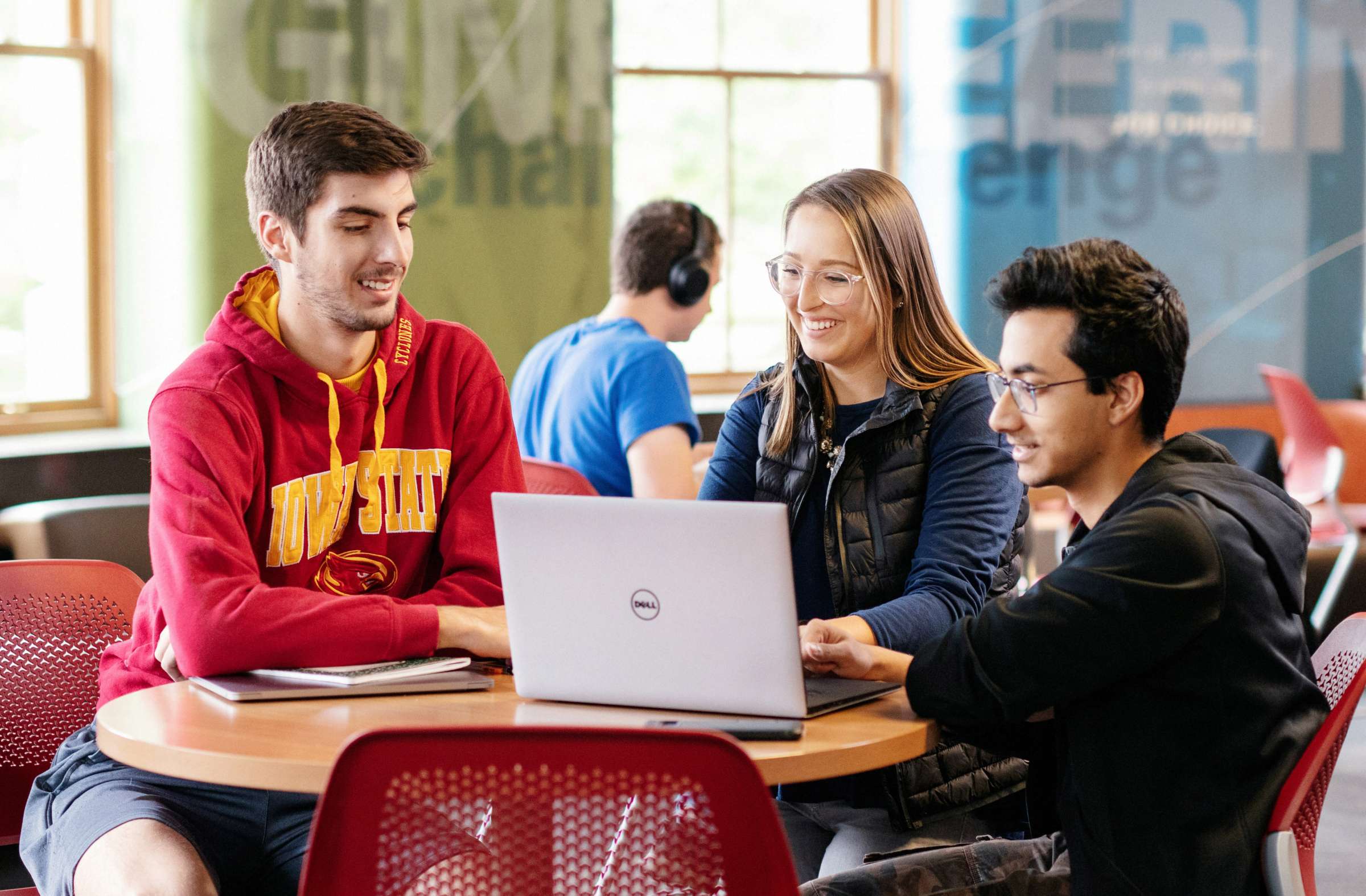 three students looking at laptop