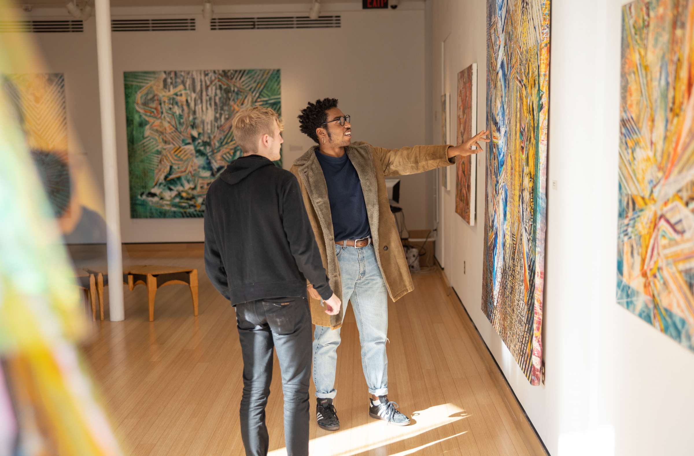 Two students looking at art in Morrill Hall.