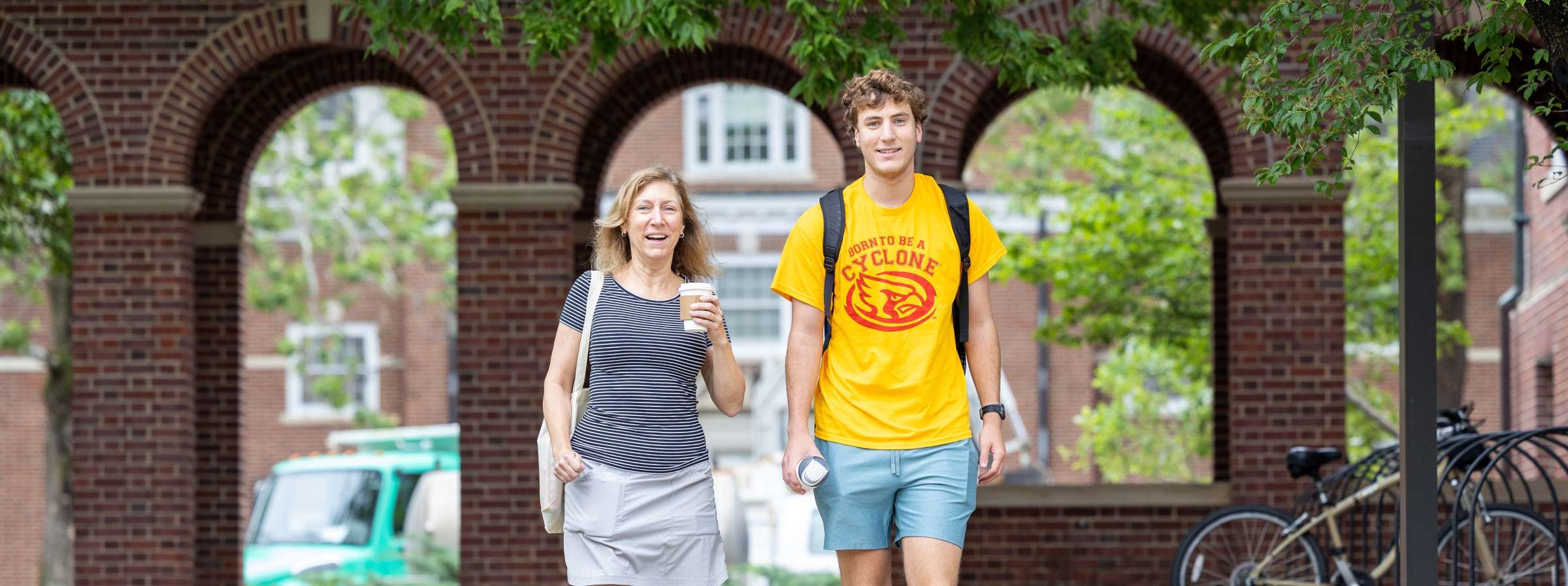 A family walking through the arches at orientation. 