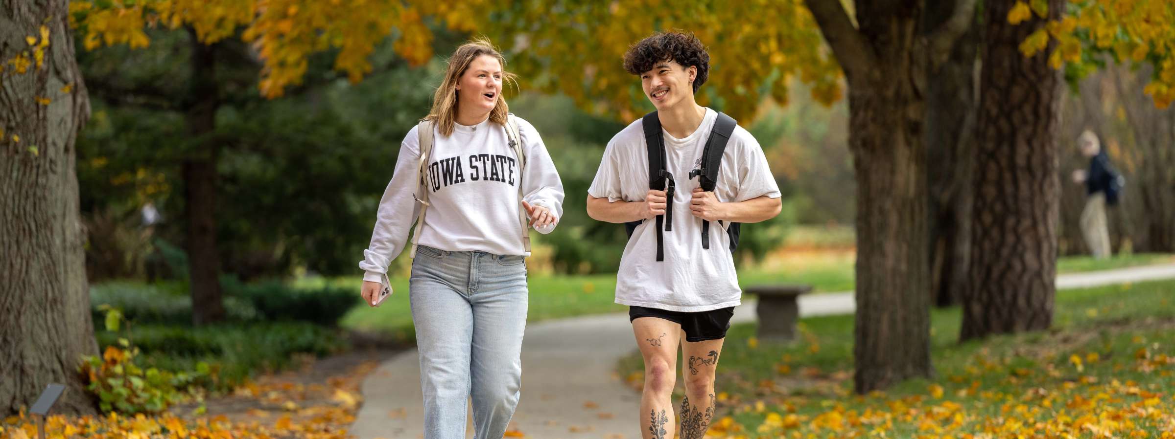 Two students walking on campus