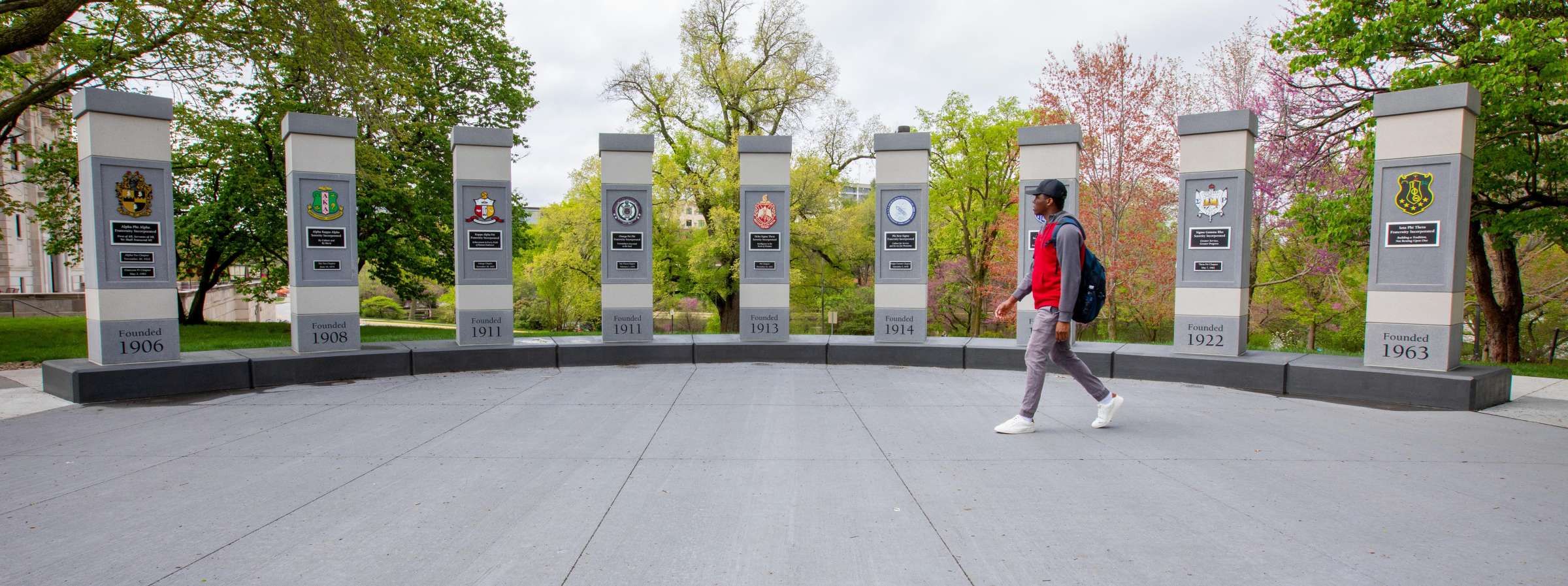 A student walks in front of the Panhellenic Plaza
